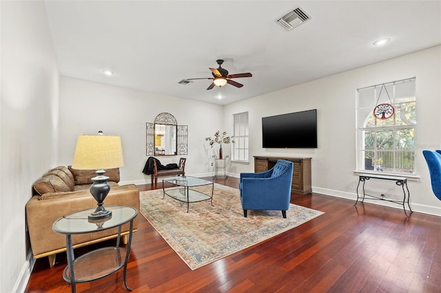 living room featuring dark hardwood / wood-style floors and ceiling fan