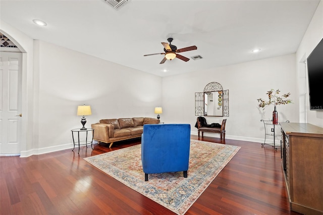 living room with ceiling fan and dark hardwood / wood-style floors