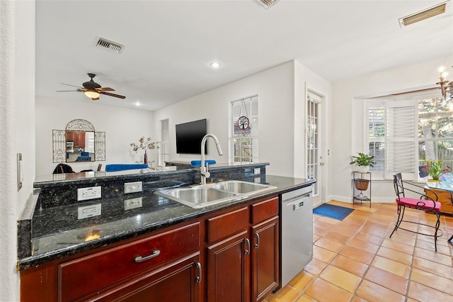 kitchen with sink, stainless steel dishwasher, ceiling fan, light tile patterned floors, and dark stone counters