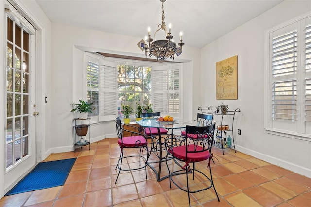 tiled dining room featuring a notable chandelier