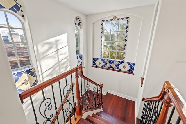 staircase with hardwood / wood-style flooring