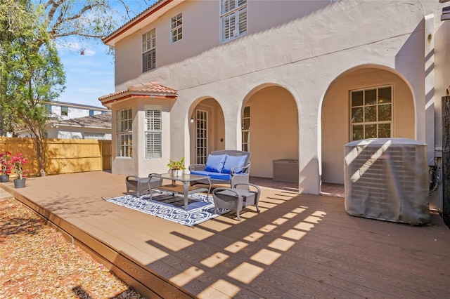 exterior space with outdoor lounge area, a deck, and central AC