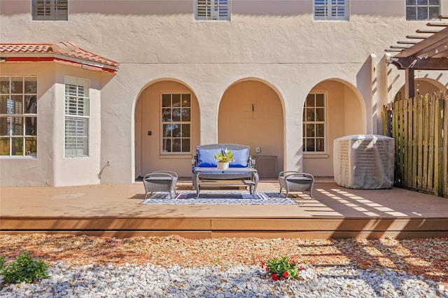 view of patio / terrace featuring central AC unit, a pergola, outdoor lounge area, and a wooden deck