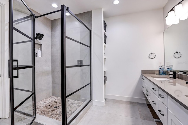 bathroom with vanity and a tile shower