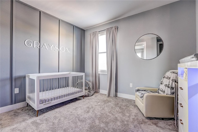 carpeted bedroom featuring a nursery area