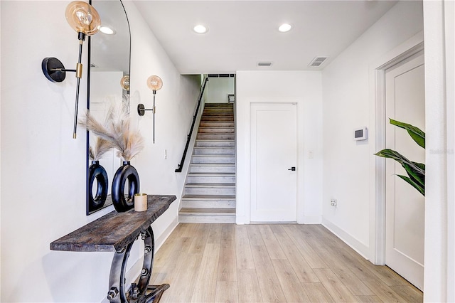 stairway featuring wood-type flooring