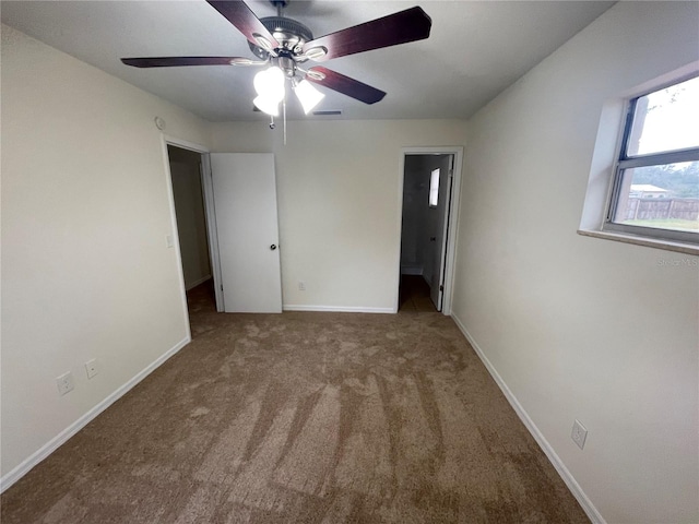 unfurnished bedroom featuring ensuite bathroom and carpet