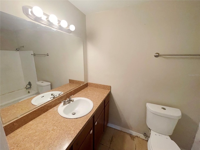 bathroom with tile patterned flooring, vanity, and toilet