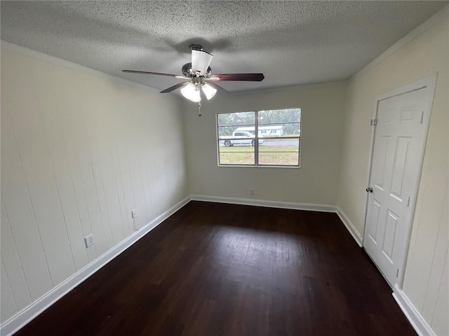 empty room featuring a textured ceiling, dark hardwood / wood-style floors, and ceiling fan