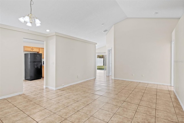 tiled empty room with an inviting chandelier and vaulted ceiling