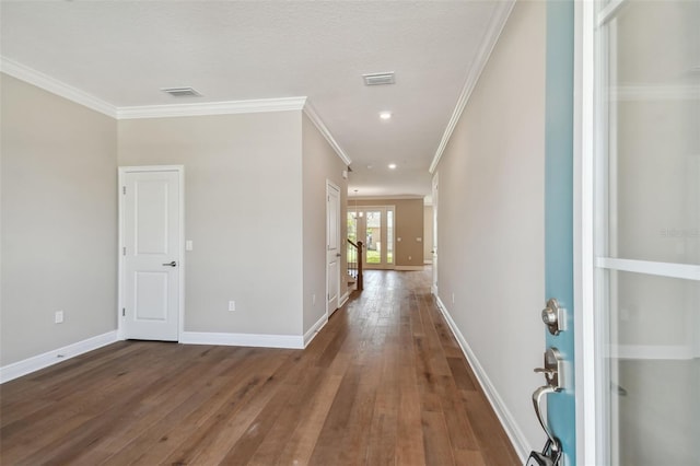 hallway featuring ornamental molding and wood-type flooring