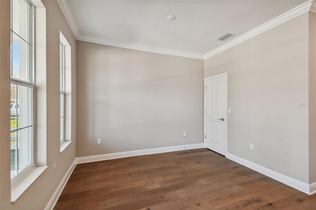 empty room with ornamental molding and dark hardwood / wood-style floors