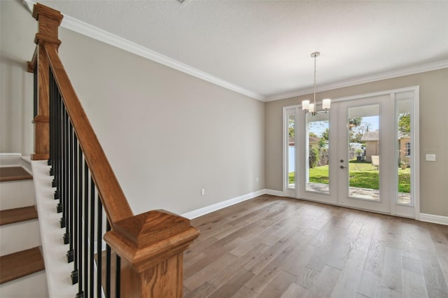 interior space with ornamental molding, a notable chandelier, and light wood-type flooring