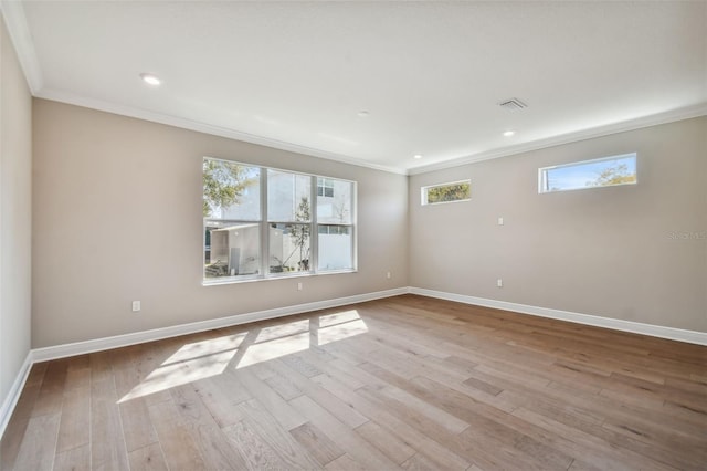 unfurnished room featuring ornamental molding and light hardwood / wood-style floors