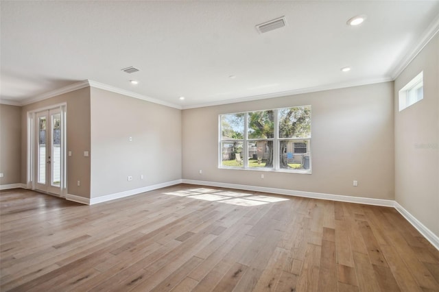 empty room with light hardwood / wood-style flooring and ornamental molding