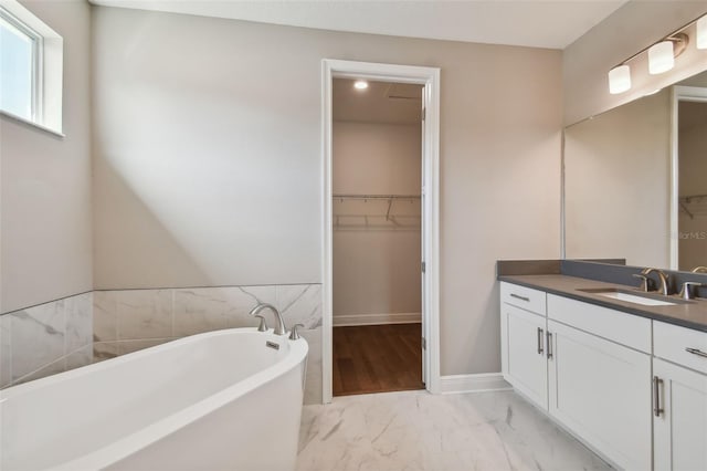 bathroom with vanity and a tub to relax in