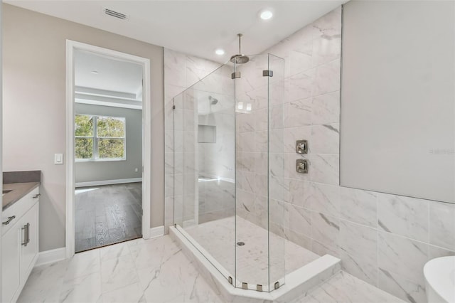 bathroom featuring vanity and a tile shower