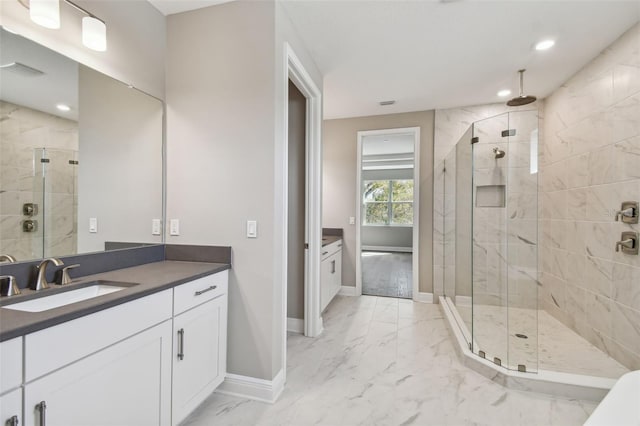 bathroom featuring vanity and a shower with door