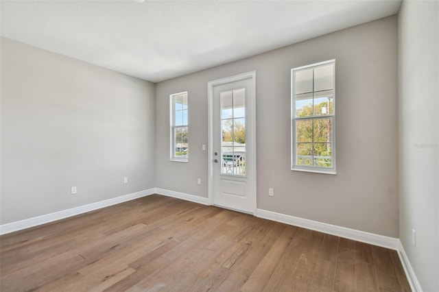 empty room with light hardwood / wood-style flooring