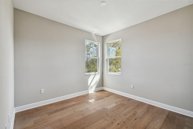 spare room with light hardwood / wood-style flooring