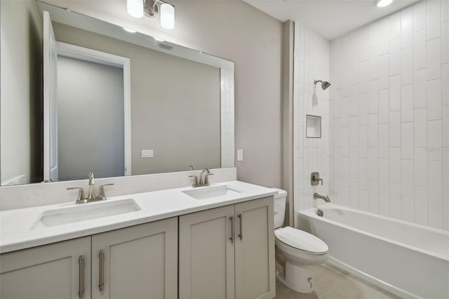 full bathroom with tiled shower / bath combo, vanity, tile patterned flooring, and toilet