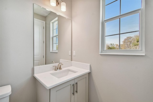 bathroom featuring vanity and toilet