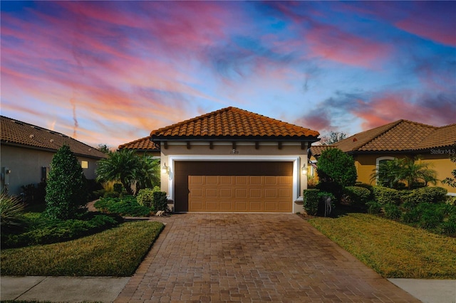 mediterranean / spanish house with a garage