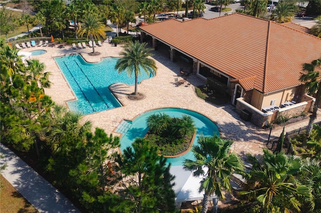 view of pool with a hot tub and a patio area