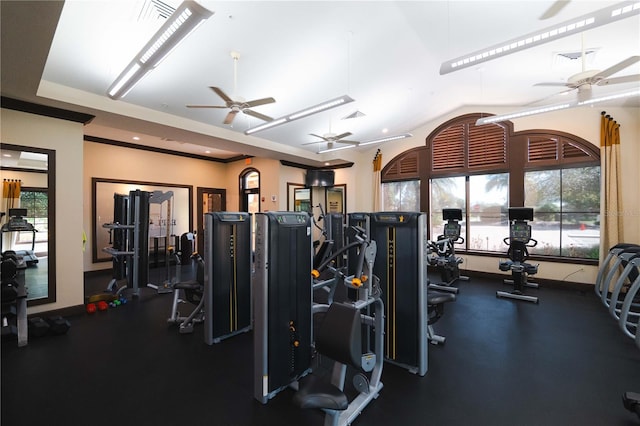 gym featuring ceiling fan and a tray ceiling