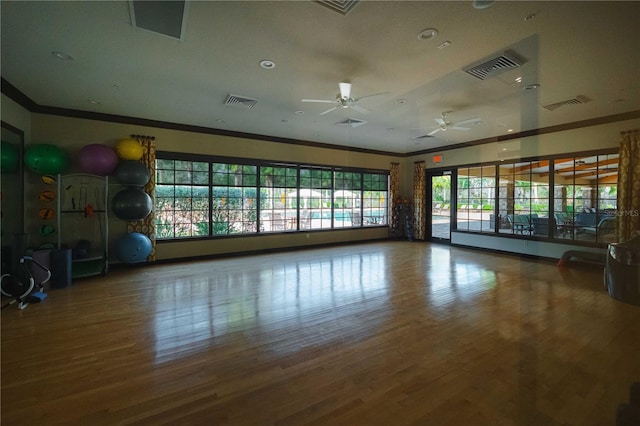 interior space with crown molding, ceiling fan, and wood-type flooring