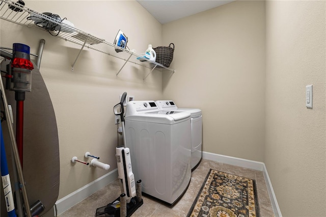 clothes washing area with washing machine and dryer