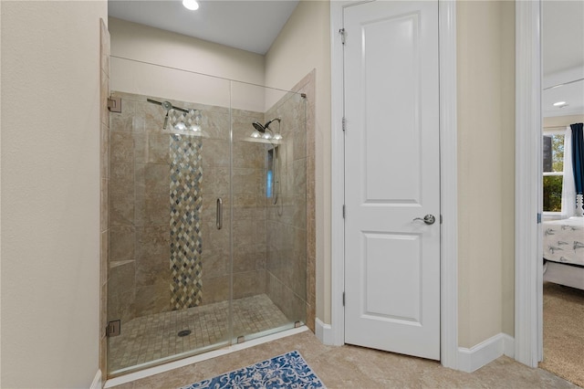 bathroom featuring a shower with shower door