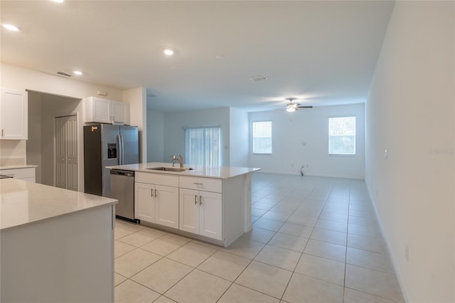 kitchen featuring stainless steel appliances, light countertops, a sink, and light tile patterned flooring