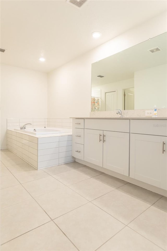 full bath featuring a bath, vanity, tile patterned flooring, and visible vents