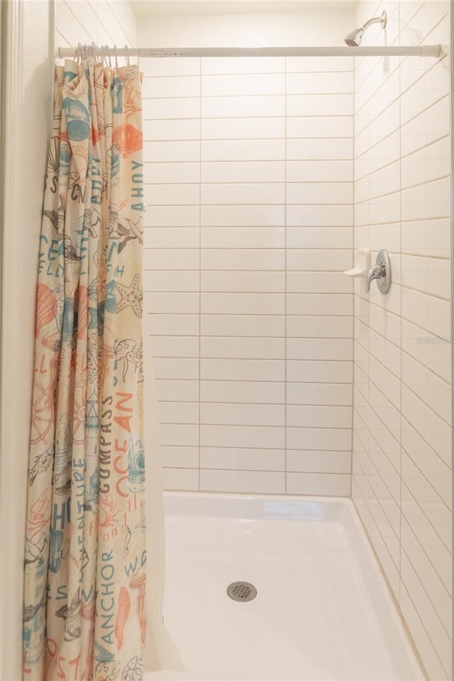 full bathroom featuring a shower stall