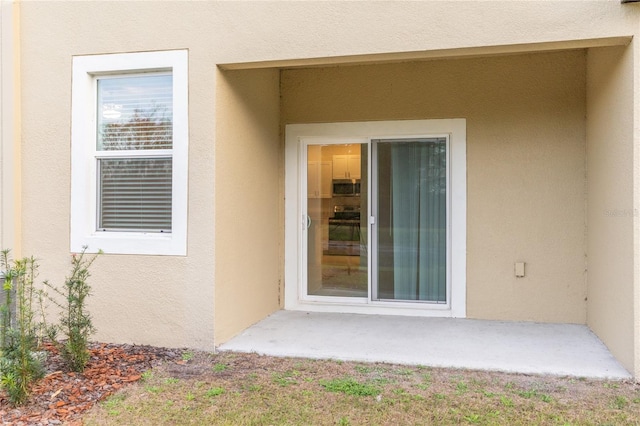 doorway to property with stucco siding