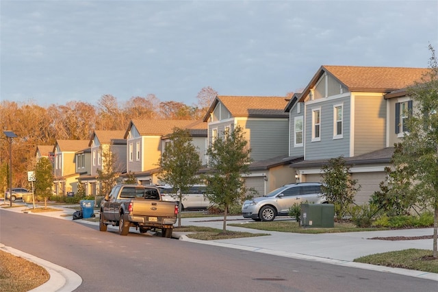 view of street with curbs, traffic signs, and a residential view