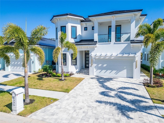 view of front of home with a garage and a front lawn