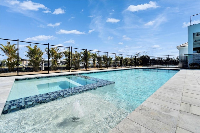 view of swimming pool with an in ground hot tub