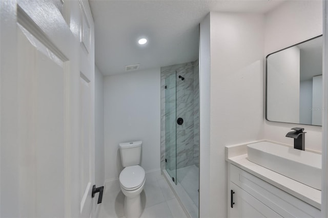 bathroom featuring vanity, tile patterned floors, a shower with door, and toilet