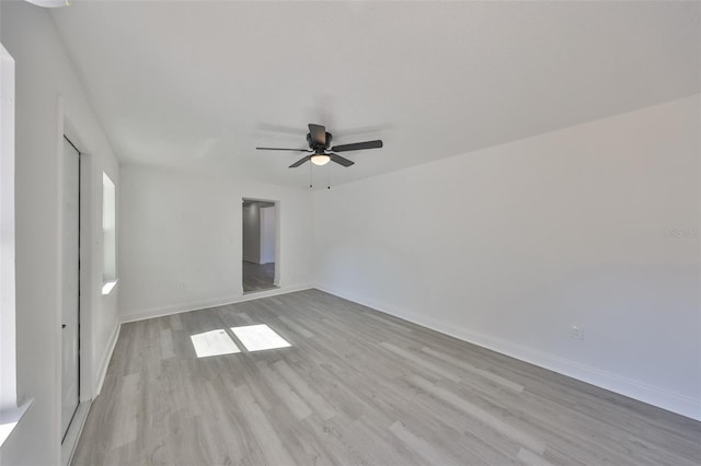 empty room with light hardwood / wood-style flooring and ceiling fan