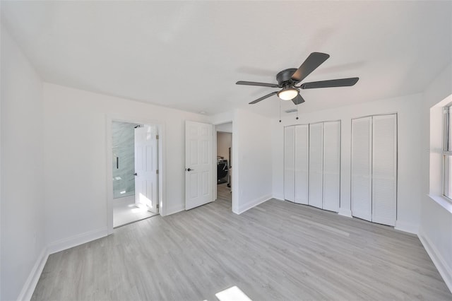 unfurnished bedroom with ceiling fan, light hardwood / wood-style floors, multiple closets, and ensuite bathroom