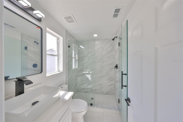 bathroom featuring vanity, walk in shower, and toilet