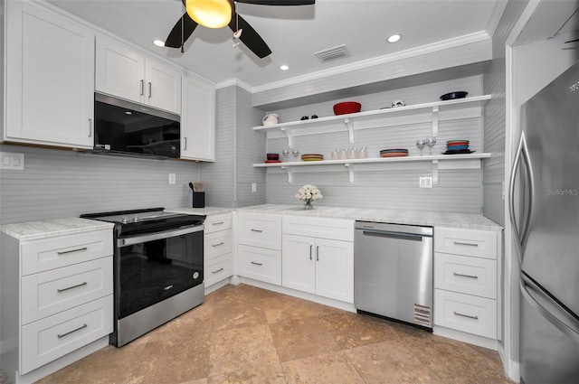 kitchen featuring light stone counters, ornamental molding, appliances with stainless steel finishes, and white cabinets