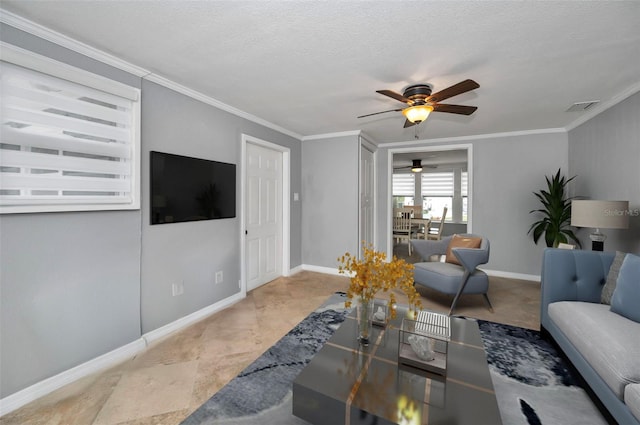 living room featuring ornamental molding, ceiling fan, and a textured ceiling