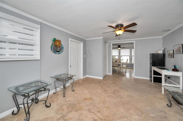 interior space with crown molding, ceiling fan, and a textured ceiling