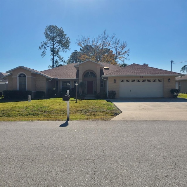 ranch-style house with a garage and a front lawn