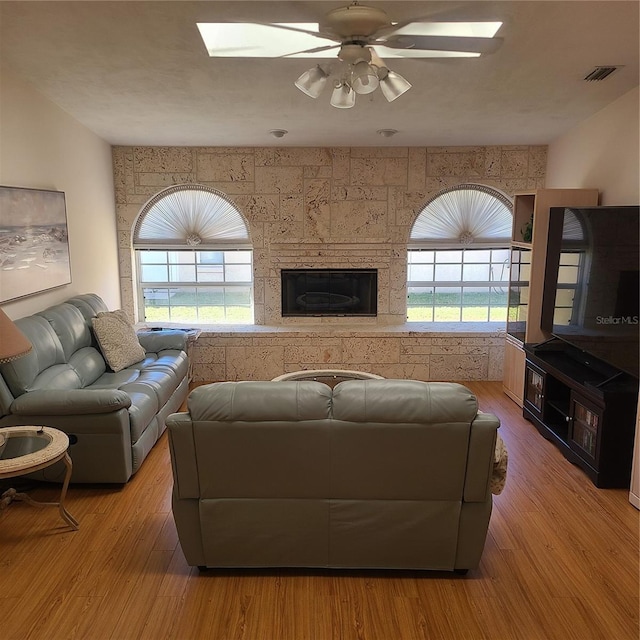 living room featuring ceiling fan and light hardwood / wood-style flooring