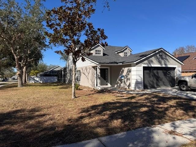 view of front of home featuring a garage and a front yard