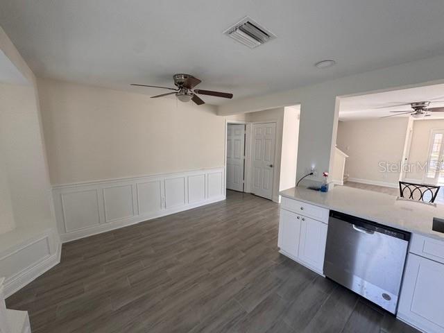 kitchen featuring white cabinetry, dark hardwood / wood-style flooring, and dishwasher